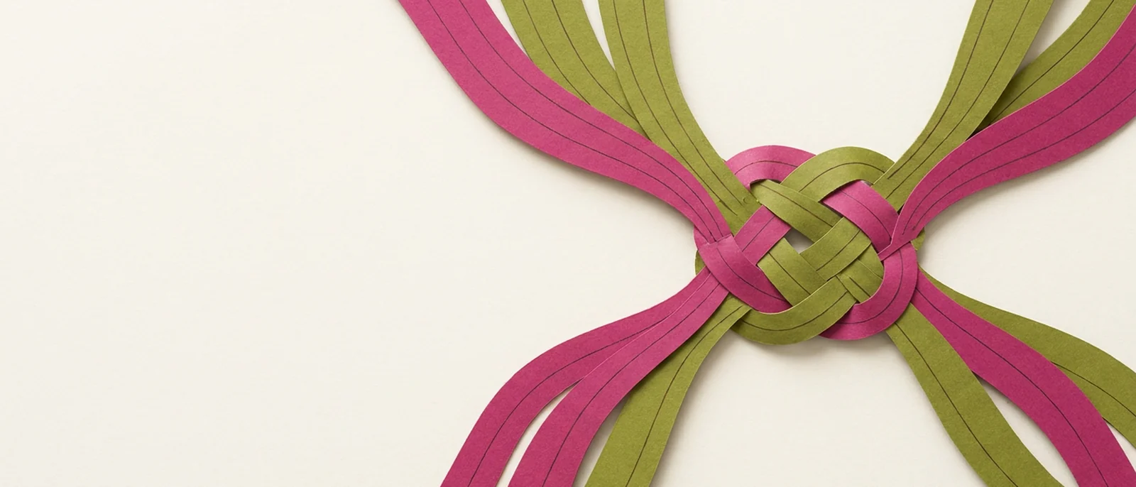Paper-craft illustration of several ribbons braided into a single knot